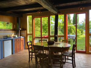 a kitchen and dining room with a table and chairs at Tenda Glamping vista sulla Valle - Podere di Maggio in Santa Fiora