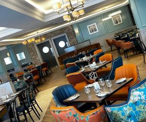 a restaurant with tables and chairs in a room at The Carrigart Hotel in Carrigart