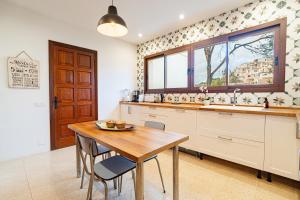 a kitchen with a table and a sink and a window at Villa Rivo - Costa de la Calma in Costa de la Calma +34 photos