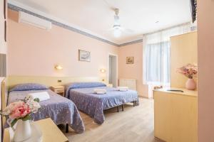 Postel nebo postele na pokoji v ubytování Hotel Marnie