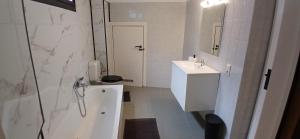 a white bathroom with a sink and a toilet at studio dans le centre de Mons in Mons