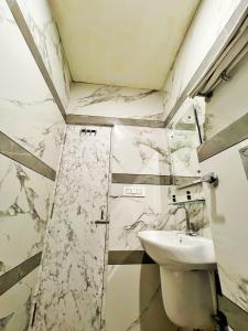 a bathroom with a sink and a toilet at HOTEL KAILASH REGENCY - Luxury Rooms Near Railway Station and Bus Terminal Ludhiana in Ludhiana