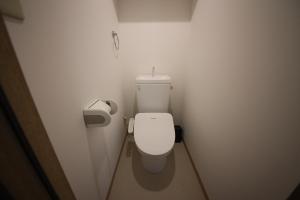 a small bathroom with a white toilet in a stall at goom Hotel Nakasu JOJO in Fukuoka