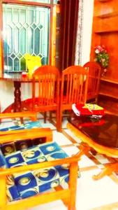 a dining room with chairs and a table and a window at Ridge Lakkar Stay in Shimla