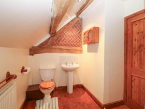 a bathroom with a toilet and a sink at Horse Shoe Cottage in Bradley in the Moors +13 photos