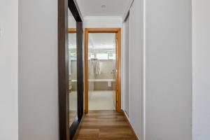 a hallway with a door leading to a bathroom at White Waters Hotel in Machico +22 photos