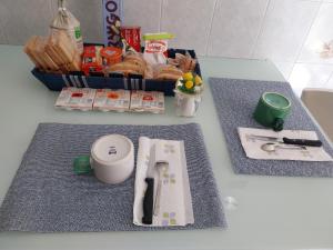 a table with a basket of pastries and a knife at Appartamento a Sampierdarena in Genoa
