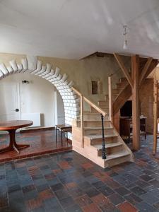 a room with a spiral staircase in a house at chambre pour 3 in Osmanville