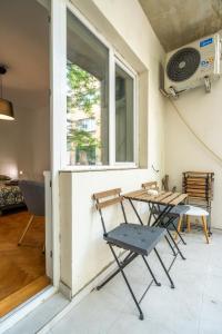 a table and chairs in front of a window at Central Sofia Gem by Vitoshka Street in Sofia