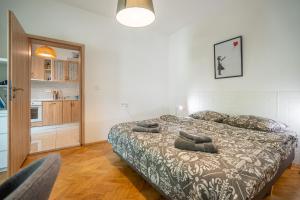 a bedroom with a bed with pillows on it at Central Sofia Gem by Vitoshka Street in Sofia