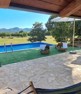 a patio with two chairs and a swimming pool at Agroturizam Villa Antonija in Neum +25 photos