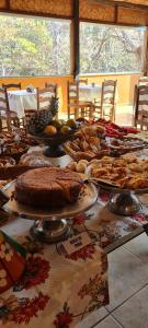 a table full of food on top at Pousada Varandas da Serra in Serra do Cipo