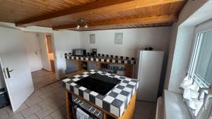 a kitchen with a stove and a refrigerator at FeWo -schiefe- Marie in Oberlungwitz