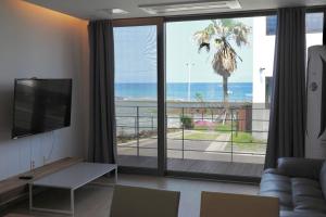 a living room with a view of the ocean at Aewol Bada 23 in Jeju