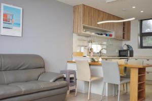 a living room with a couch and a table at Aewol Bada 23 in Jeju