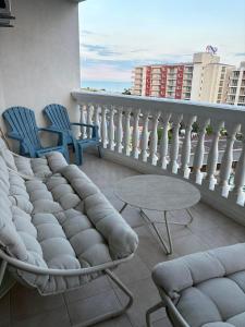 a balcony with two chairs and a table and chairs at Miramar Palace 615 in Sunny Beach