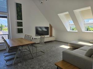 a living room with a table and a tv at Alpine Haven in Bovec
