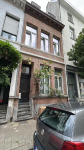 a car parked in front of a brick house at Holiday Home in Antwerp in Antwerp
