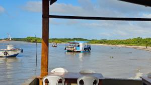 a view of a boat on a river with a beach at Praias e centro histórico in São Luís