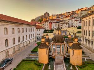 a view of a building with a city in the background at Casa da Baixa by PURUS in Coimbra