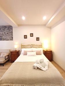 a bedroom with a large bed with towels on it at Casa Maisimino in Cudillero