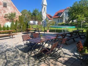 a patio with tables and chairs and an umbrella at Landgasthof - Hotel zum Stern in Linden