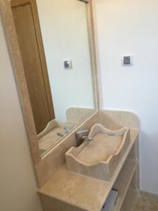 a bathroom with two sinks and a mirror at Villa Cape Vergoti in Lozenets