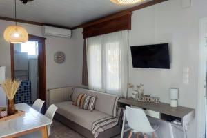 a living room with a couch and a table at Nikis House in Keramoti