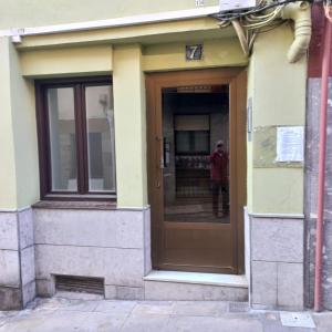a person standing in the doorway of a building at Apartamento Kuttun Bermeo in Bermeo