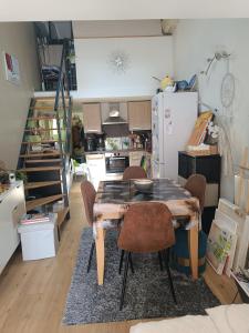 a kitchen with a table and chairs in a room at Maison hauteur Nice in Nice +3 photos