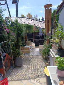 a patio with a lot of plants and chairs at Maison hauteur Nice in Nice
