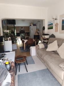 a living room with a couch and a table at Maison hauteur Nice in Nice