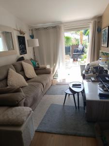 a living room with a couch and a table at Maison hauteur Nice in Nice