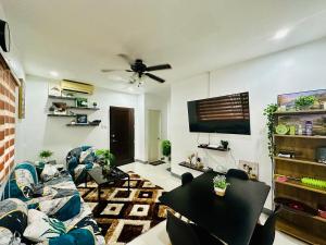 a living room with a couch and a table at Rai Staycation in Sampong
