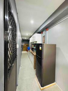 a kitchen with a stainless steel refrigerator and a counter at Rai Staycation in Sampong