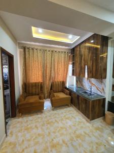 a living room with two chairs and a sink at hidden gem for you in Rawalpindi
