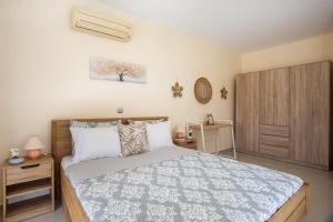 a bedroom with a bed and a wooden cabinet at Palmtrees Apartments in Afantou