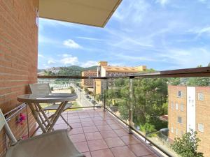 a balcony with a table and a view at Reconnectar Malgrat de Mar Colom I in Malgrat de Mar