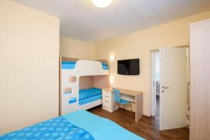 a bedroom with a bunk bed and a desk at Guesthouse Opara in Piran