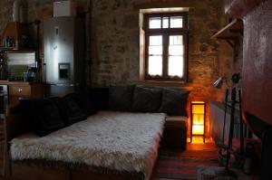a living room with a couch and a window at The Mountain House -mountain getaway in Syrrako