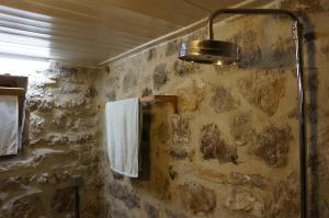 a bathroom with a shower with a white towel at The Mountain House -mountain getaway in Syrrako +60 photos