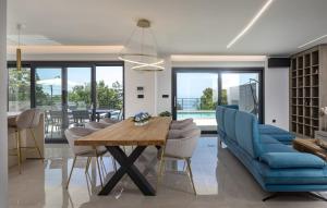 a living room with a dining room table and chairs at Villa Aura by Villas Guide in Urinj