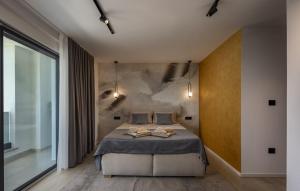 a bedroom with a bed with two towels on it at Villa Aura by Villas Guide in Urinj +12 photos