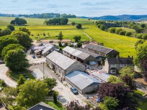 an aerial view of a farm with buildings at Meadow View in Buxton