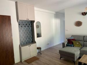 a living room with a couch and a cabinet at Apartament przy Górze Witosza in Staniszów