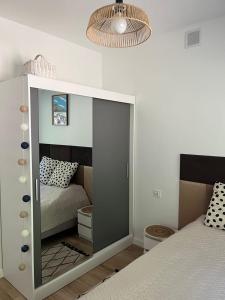 a bedroom with a bed with a large glass door at Apartament przy Górze Witosza in Staniszów +7 photos