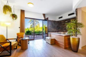a bathroom with a large tub and a large window at Golf & Spa Kunětická Hora in Dritec +62 photos