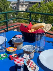 a blue table with a basket of food on it at Occitania Centre Toulouse Matabiau in Toulouse