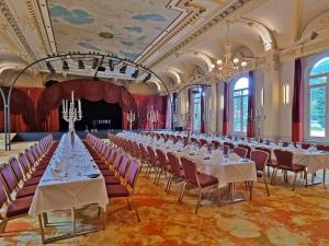 una grande sala banchetti con tavoli e sedie di Hotel Reine Victoria a Sankt Moritz