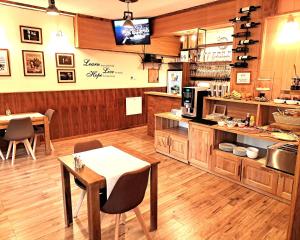 a kitchen with a counter and a table and chairs at Plitvice Lower Lakes Rooms in Plitvica Selo